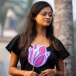 Medium close-up of 3D purple tulip handpainted artwork on a black cotton dress