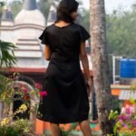 Back view showing the clean fit and silhouette of the black Malai Cotton dress