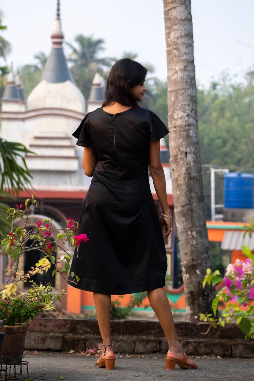Back view showing the clean fit and silhouette of the black Malai Cotton dress