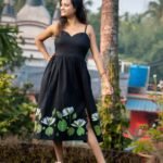 Full-length shot of Shaluk hand-painted black dress with thin shoulder straps and gathered waist