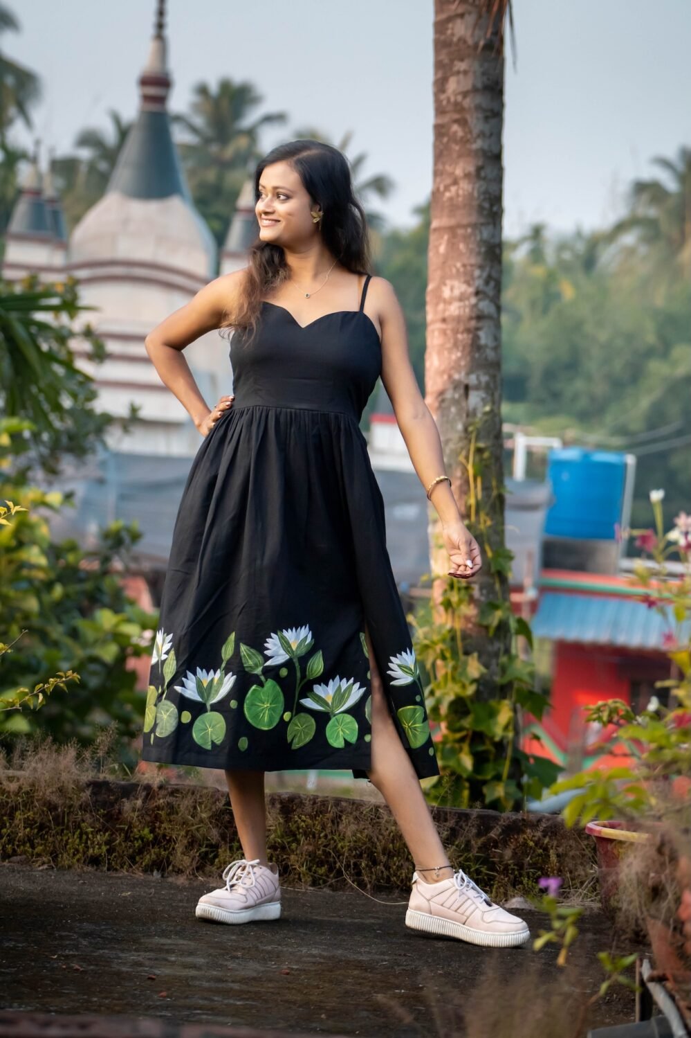 Full-length shot of Shaluk hand-painted black dress with thin shoulder straps and gathered waist
