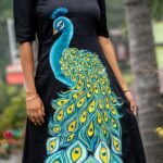 Mid-section view showing vibrant blue and yellow hand painted peacock feathers on a black dress
