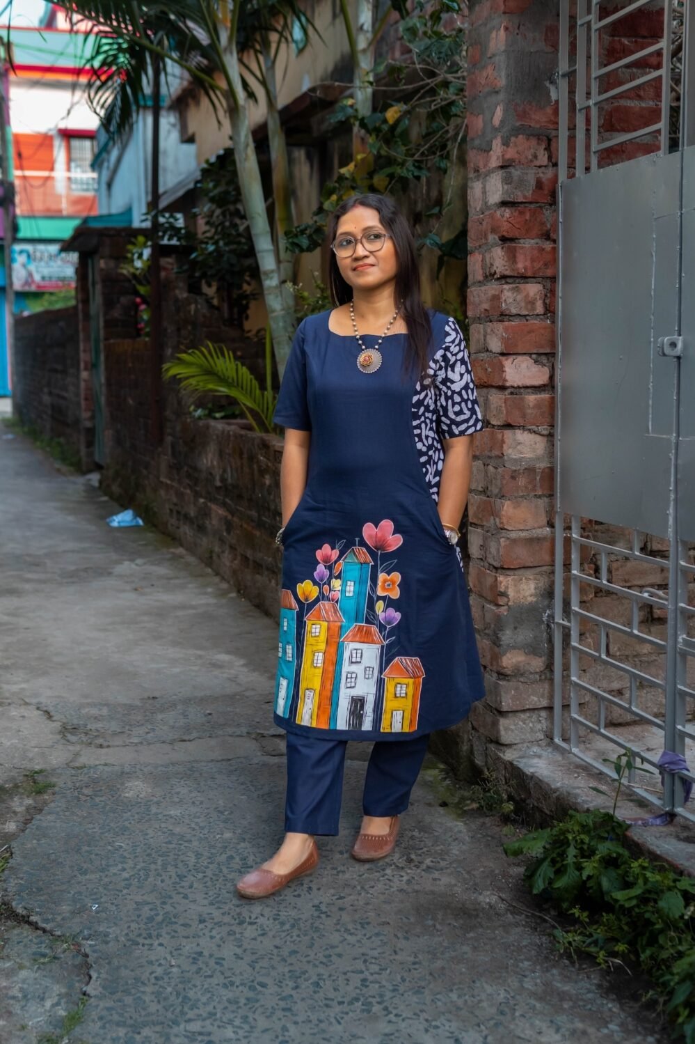 Navy blue hand-painted pure cotton co-ord set featuring a colorful cityscape motif and straight trousers.