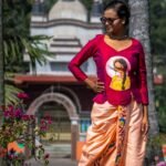Full-length pose showing the draped silhouette of the Nayantara hand-painted magenta top and peach dhoti pant set