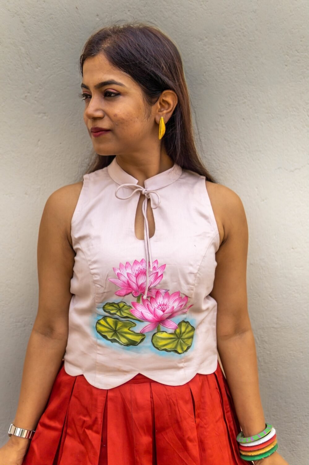 Front close-up view highlighting hand-painted lotus artwork and scalloped hem on the off-white top