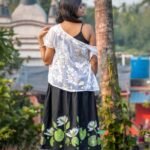 Back view showing the lower flared hem decorated with hand-painted water lilies and green lily pads