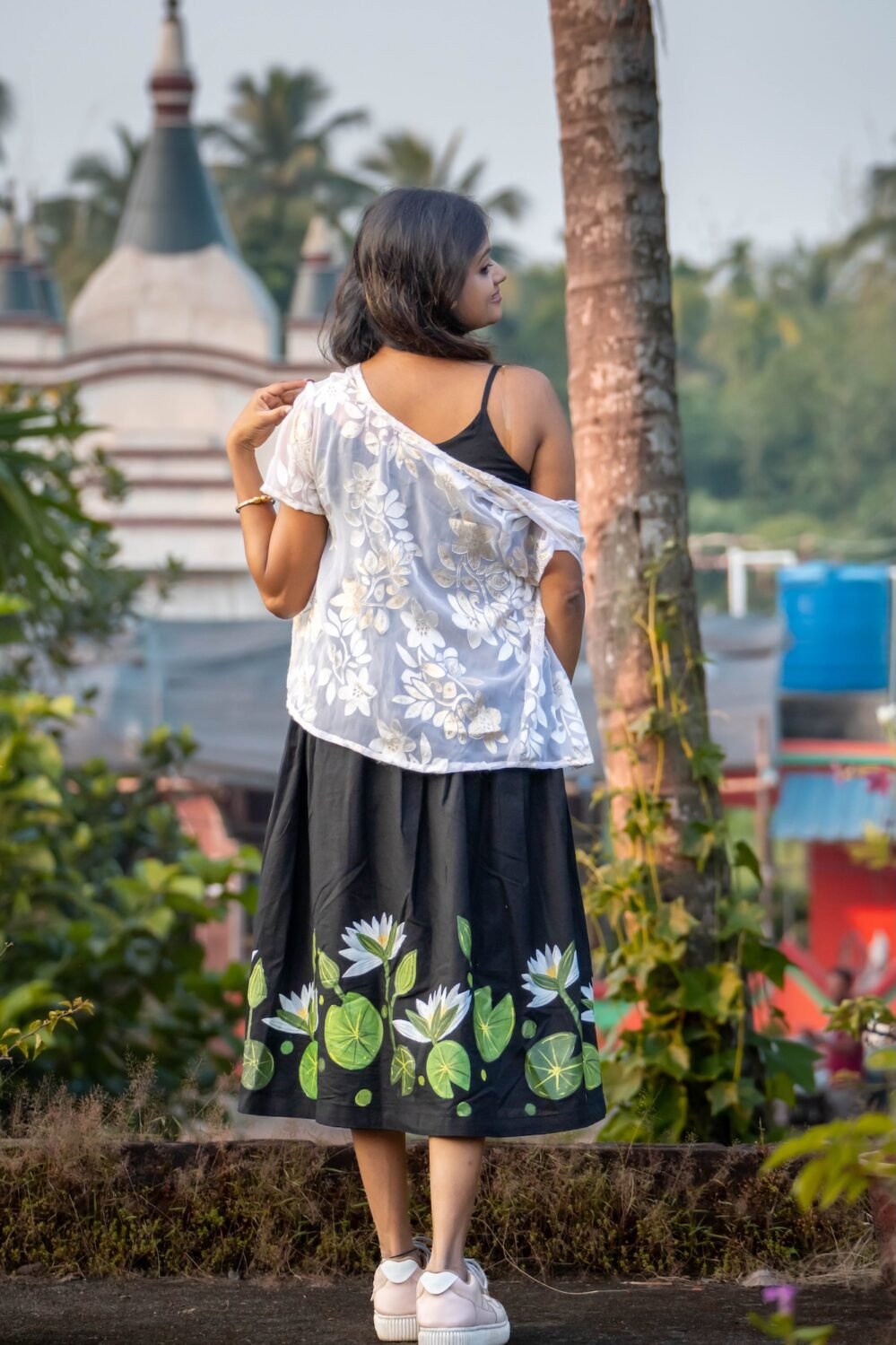 Back view showing the lower flared hem decorated with hand-painted water lilies and green lily pads