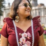 Close-up of hand-painted orchid flowers on the bodice of Mridu maroon cotton dress.