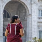 Back view showing ruffle shoulder details and white lace trims of Mridu dress.