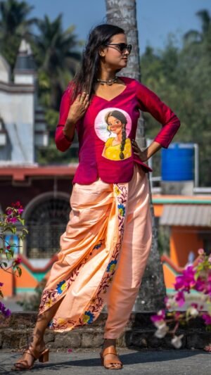 Outdoor shot of model wearing the complete Nayantara hand-painted magenta top and peach dhoti co-ord set