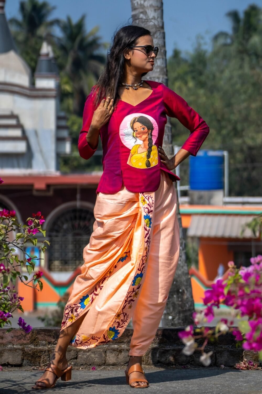 Outdoor shot of model wearing the complete Nayantara hand-painted magenta top and peach dhoti co-ord set