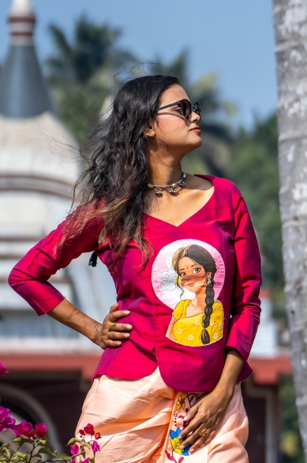 Waist-up shot of model wearing the V-neck magenta top with hand-painted portrait artwork and cotton lining