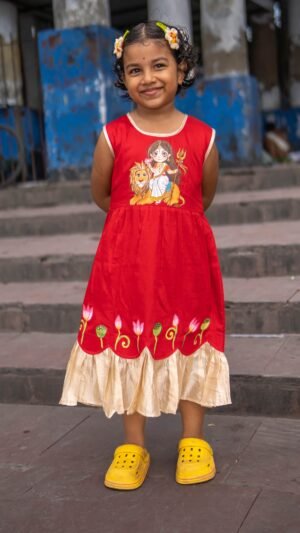 Full front view of girl smiling in red handpainted Durga Rani frock with lotus motifs by Aankibukis Couture.