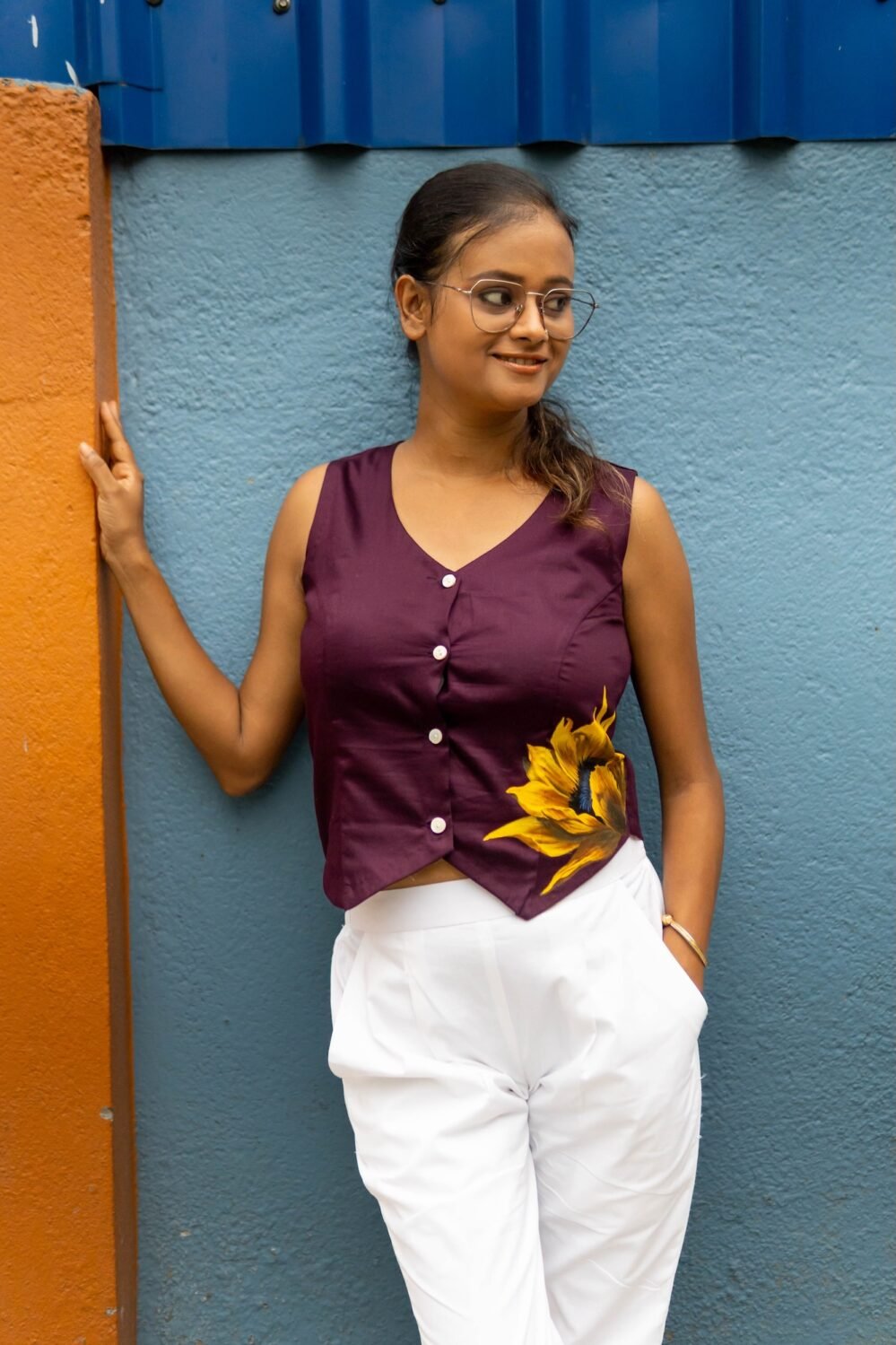 Front view of a woman wearing Aankibukis Couture purple handpainted sunflower waist coat without a inner layer.