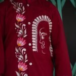 Close-up of the hand-painted line art Durga motif and pink lotus vine on the chest of the maroon boys' kurta.