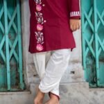 Detailed lower-body shot showing the off-white cotton dhoti paired with the hand-painted maroon lotus vine kurta for boys.