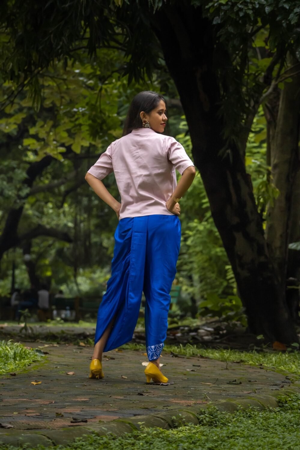 Full back view of woman wearing CharuNeela royal blue dhoti and beige layering jacket