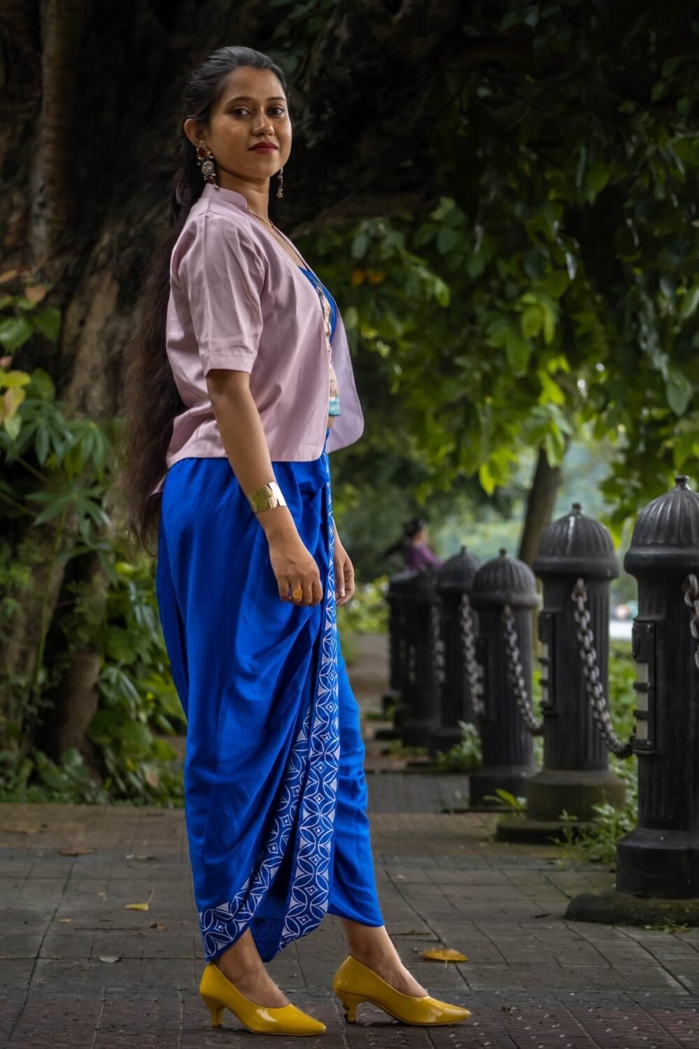 Side angle of CharuNeela 3-piece set styling royal blue dhoti with lightweight beige jacket