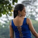 Back view showing criss-cross lace-up design of royal blue backless blouse