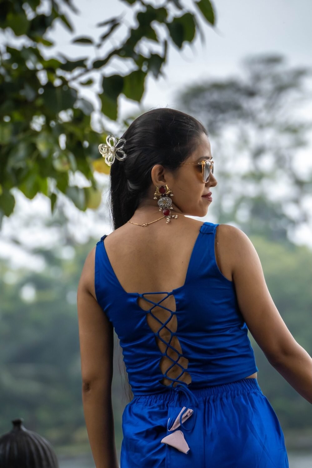 Back view showing criss-cross lace-up design of royal blue backless blouse