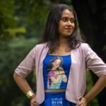 Medium shot of woman posing in CharuNeela hand painted royal blue blouse and beige jacket