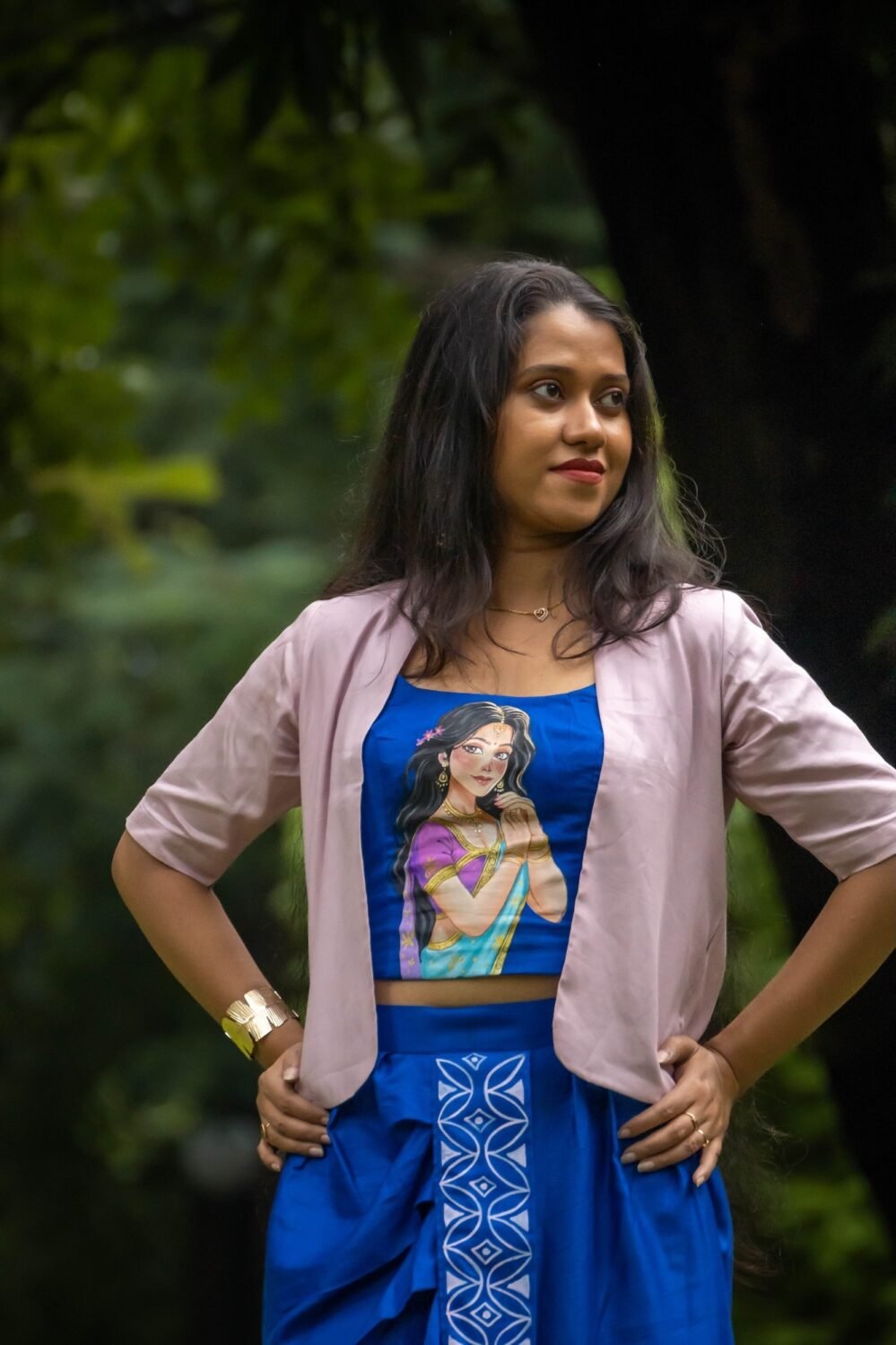 Medium shot of woman posing in CharuNeela hand painted royal blue blouse and beige jacket