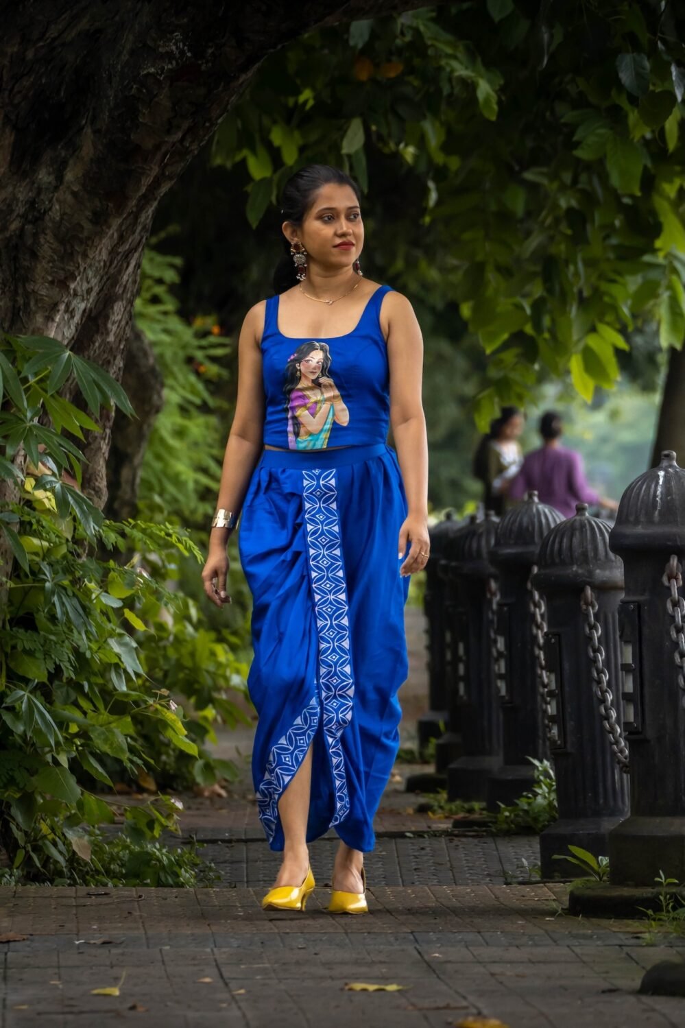 Model walking in CharuNeela hand painted 2-piece royal blue dhoti set