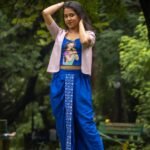 Model posing in CharuNeela 3-piece hand painted royal blue dhoti set with beige jacket by Aankibukis Couture