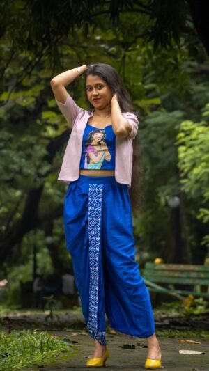 Model posing in CharuNeela 3-piece hand painted royal blue dhoti set with beige jacket by Aankibukis Couture