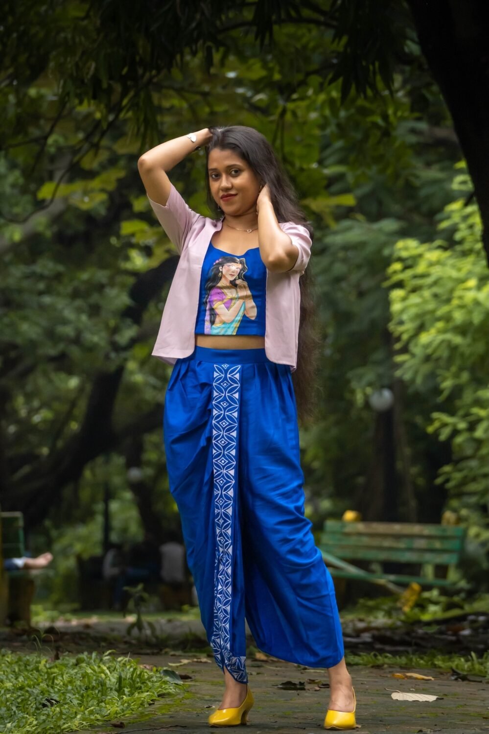 Model posing in CharuNeela 3-piece hand painted royal blue dhoti set with beige jacket by Aankibukis Couture