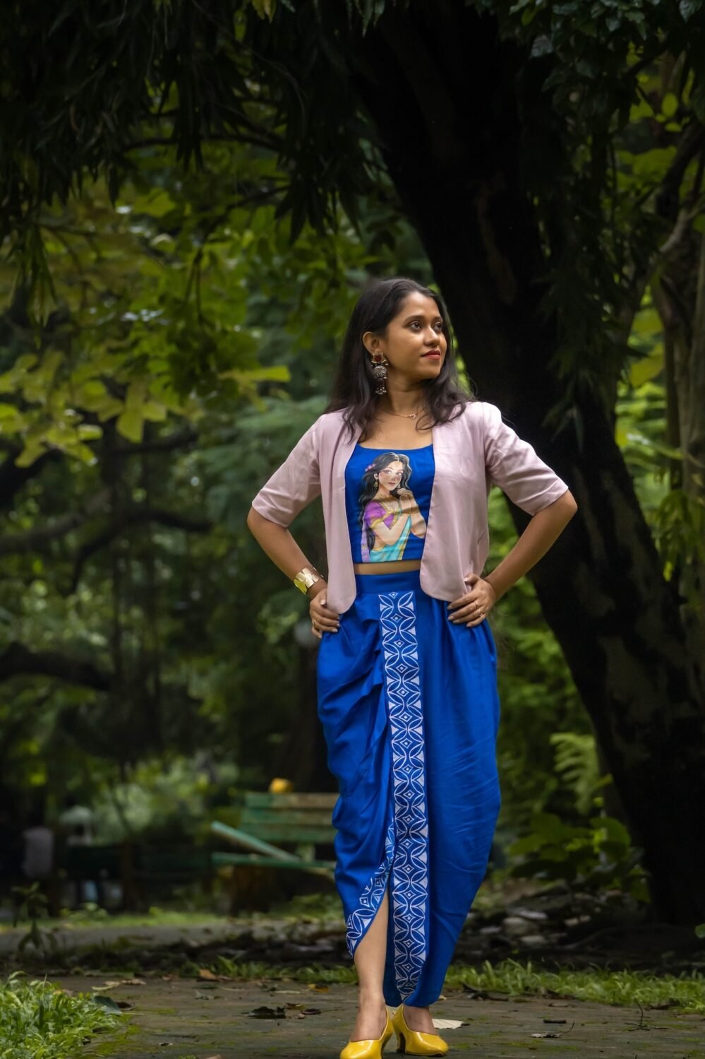 Model posing outdoors in CharuNeela 3-piece hand painted royal blue dhoti set by Aankibukis Couture