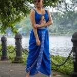 Full-length view of woman wearing CharuNeela royal blue pre-draped dhoti and hand painted blouse