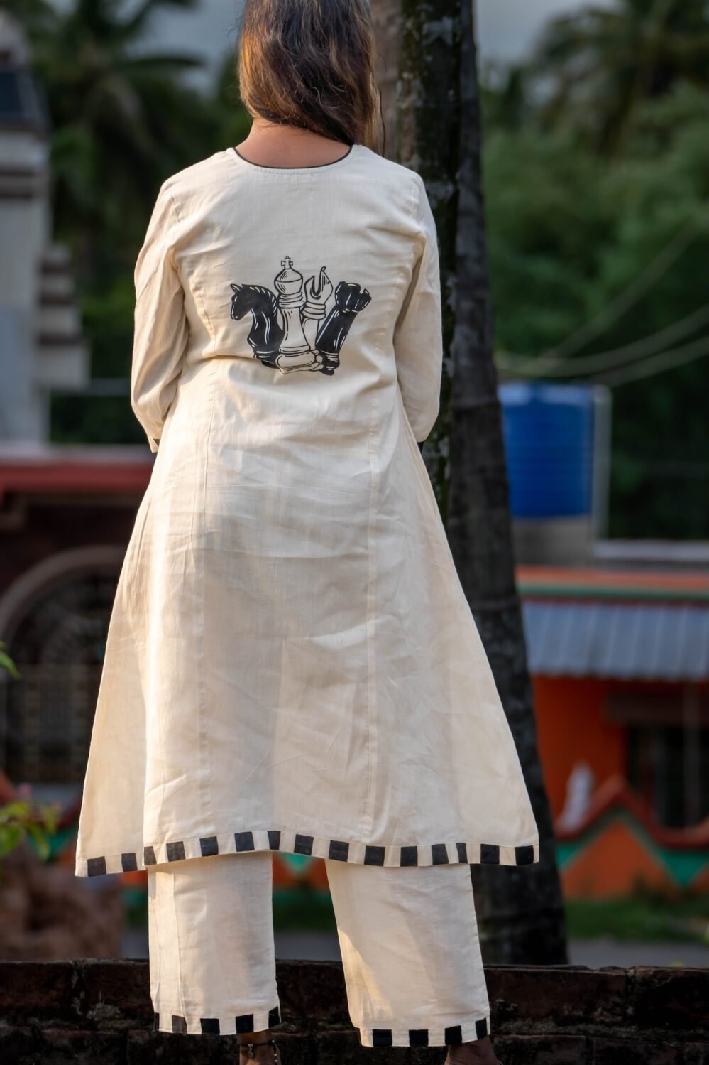 Full Rear view of white Kora Khadi co-ord set featuring handpainted chess piece artwork on the back