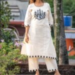 Woman wearing white handpainted Kora Khadi chess co-ord set with black checkered trims by Aankibukis Couture