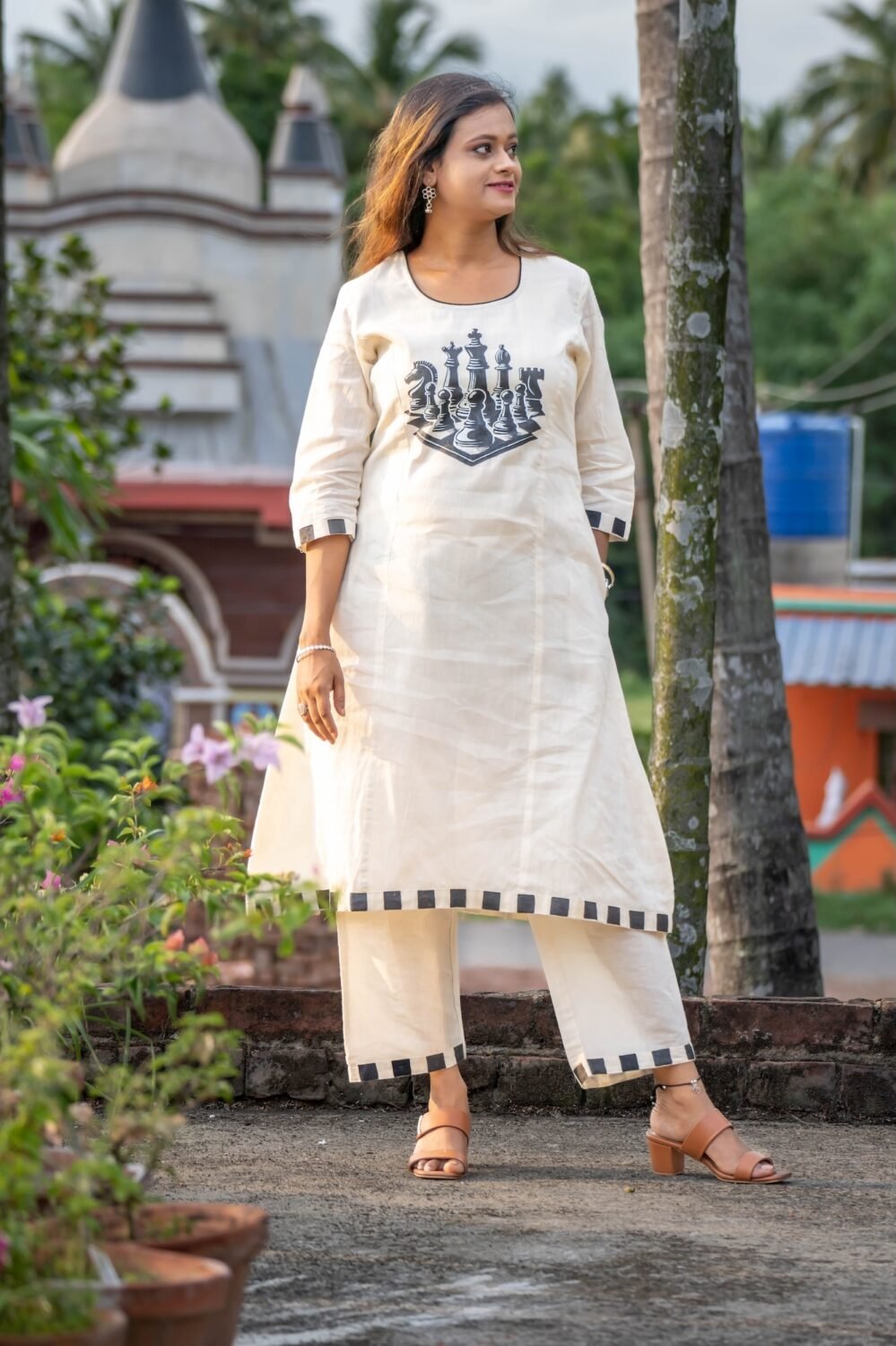 Woman wearing white handpainted Kora Khadi chess co-ord set with black checkered trims by Aankibukis Couture