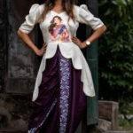 Woman wearing hand painted off-off-white top and Magenta dhoti co-ord set by Aankibukis Couture.
