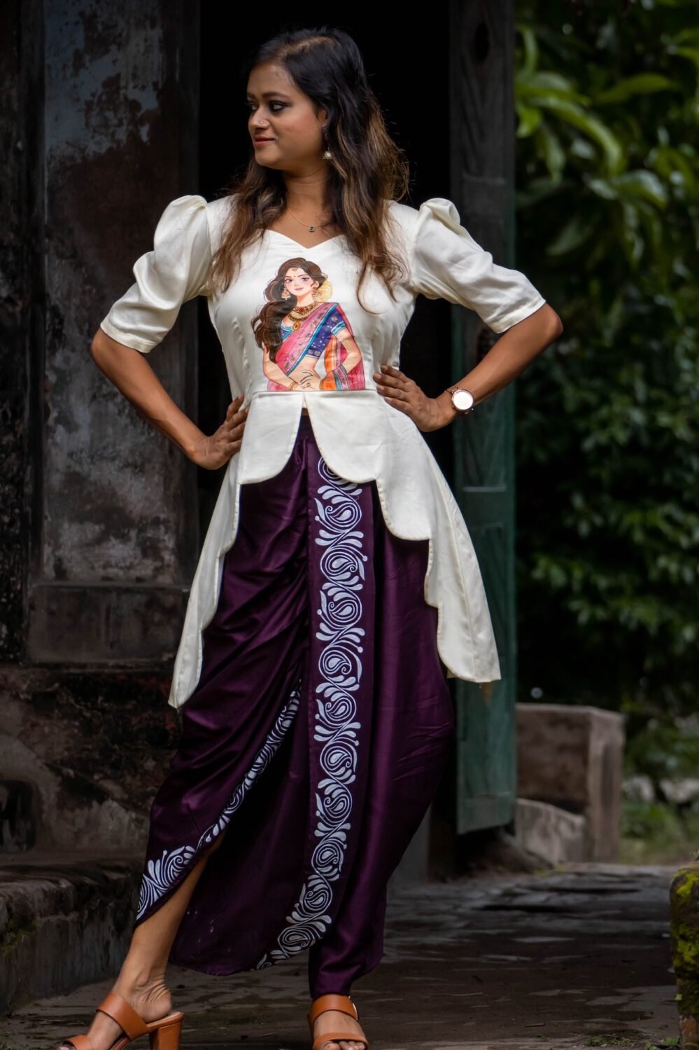 Woman wearing hand painted off-off-white top and Magenta dhoti co-ord set by Aankibukis Couture.