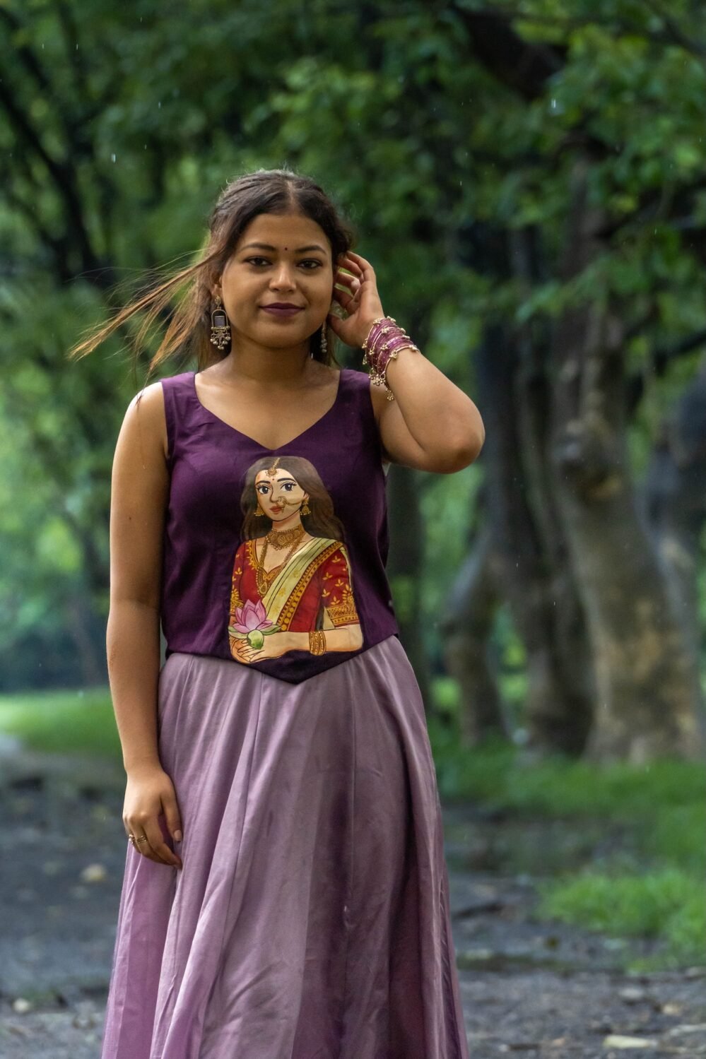 Front view of woman wearing sleeveless Malai cotton top featuring artisan painting of Maa Durga.