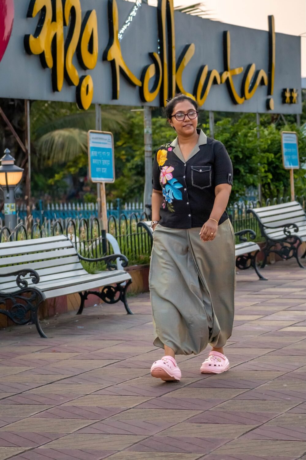 Macro view of hand-painted botanical motifs and contrast button-down placket on a black handloom cotton blazer-collar shirt.
