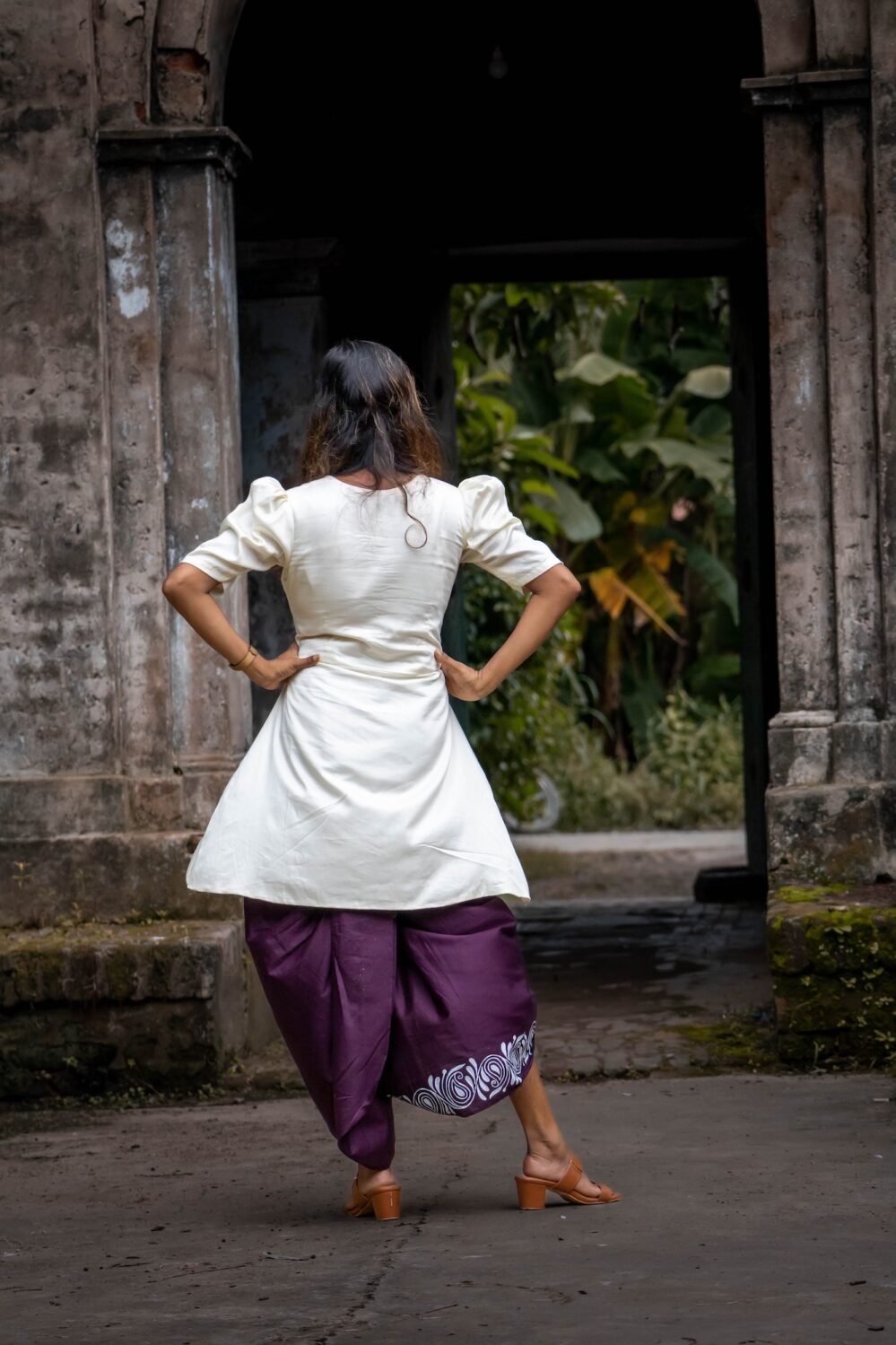 Full-length pose from back side displaying the complete fusion outfit paired with block heels.