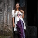 Side profile showing the high-low flared hem of the top paired with the ready-to-wear dhoti.