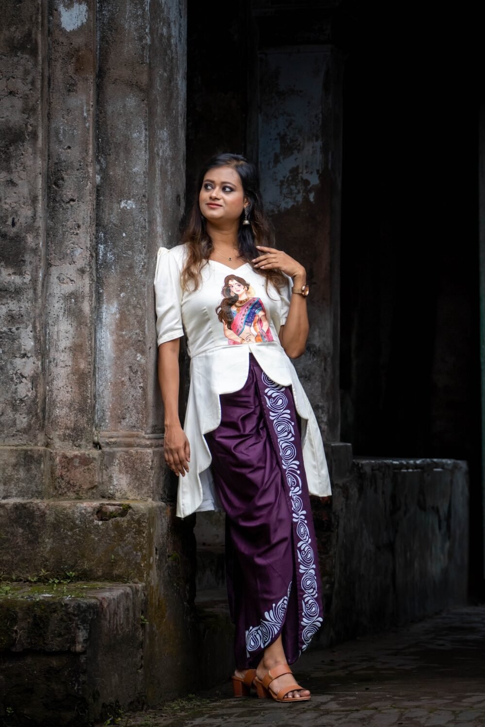 Side profile showing the high-low flared hem of the top paired with the ready-to-wear dhoti.