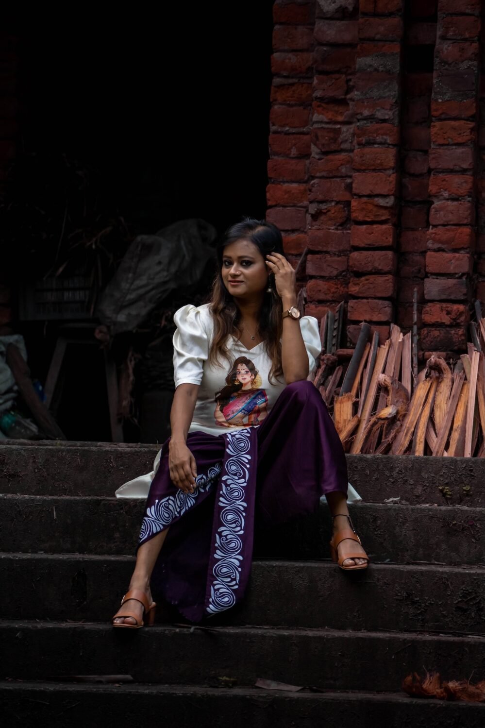 Full view of the Indo western fusion set sitting on stair and flow of the 36-inch dhoti.