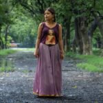 Artisan hand-painted ethnic top styled for festivals and family gatherings.