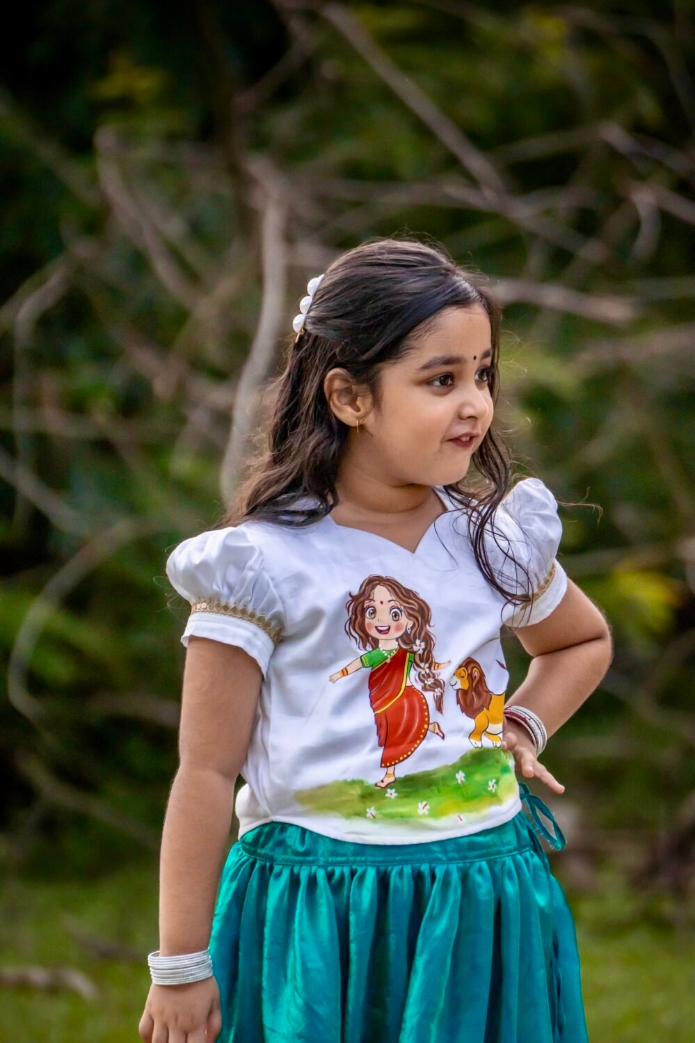 Close-up shot showing the hand-painted cartoon artwork of Maa Durga and lion on a white puff-sleeve top for girls.