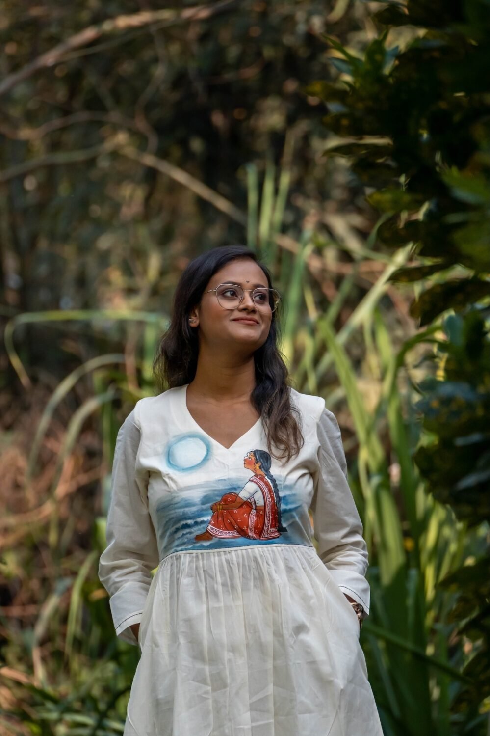 Half-length portrait of a smiling woman wearing the Kora Moon Light handpainted co-ord top.