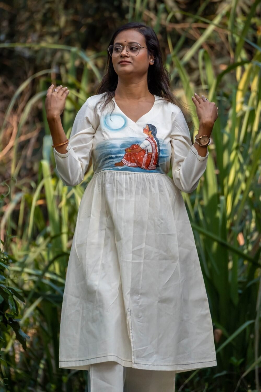 Woman posing outdoors wearing off-white handpainted Kora Moon Light Co-ord set with pants by Aankibukis Couture