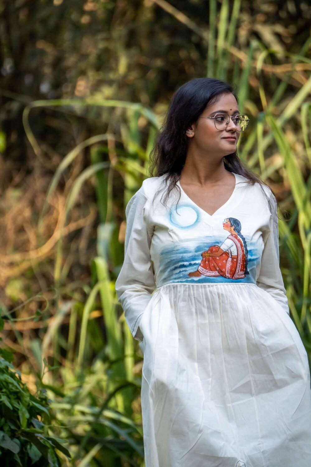 Upper-body shot of woman in v-neck handpainted kora khadi co-ord top in an outdoor setting.