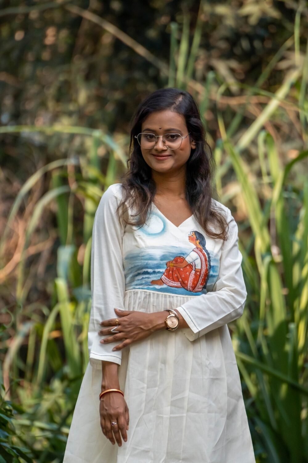 Close-up of off-white kora khadi tunic showing handpainted moon light theme artwork on the bodice.