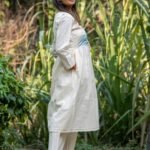 Side profile of woman wearing Kora Moon Light Co-ord set with hands in practical side pockets.